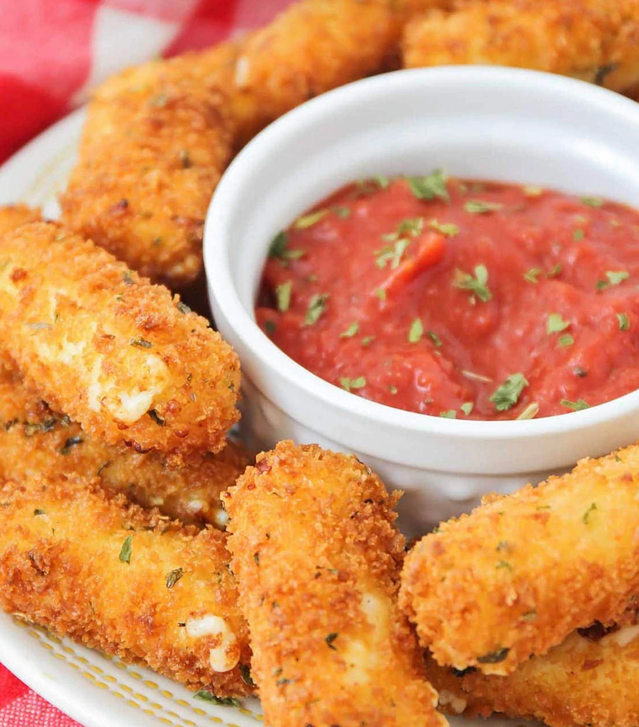 Golden breaded mozzarella sticks with marinara sauce